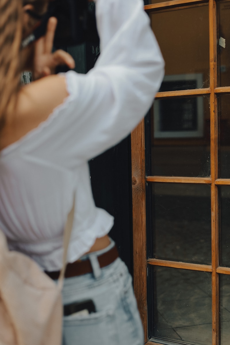 a woman standing in front of a door talking on a cell phone